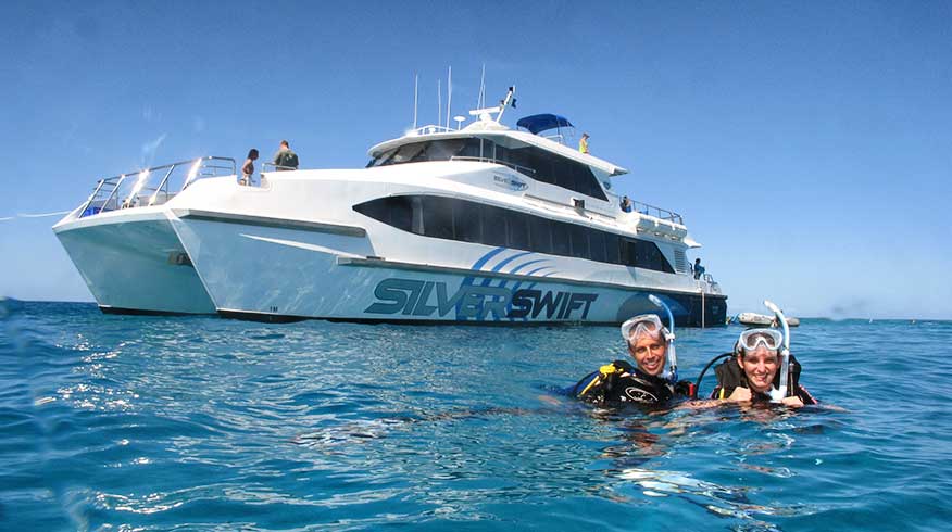 Scuba Divers next to dive boat Silverswift